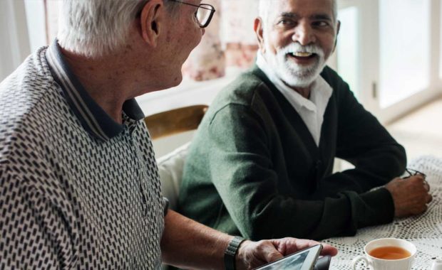 scnova-volunteer-going-over-health-plan-with-elder-man