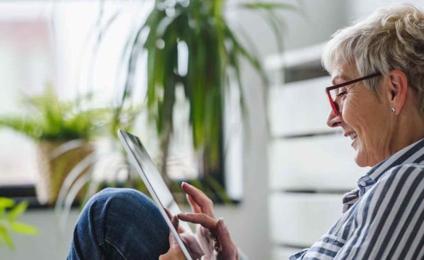 women happy in her home on her tablet