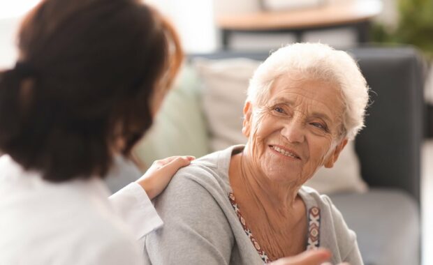 young doctor visiting elderly woman at home