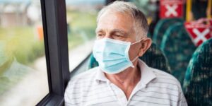 senior man with protective face mask in bus transport
