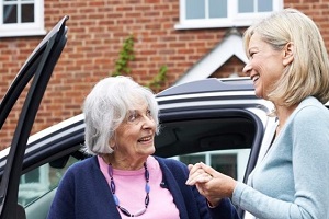 young women helping an old lady for Senior Citizen Transportation