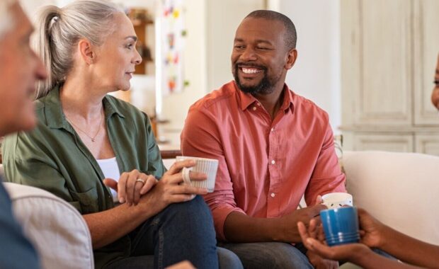senior and mature couples in conversation at home