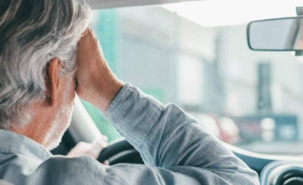 old businessman feeling headache in car