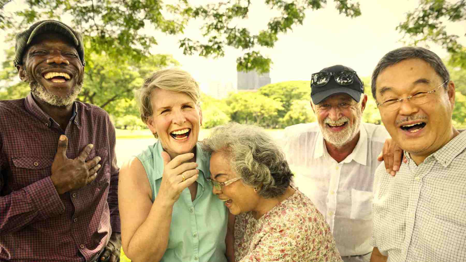 Seniors outside laughing and hugging