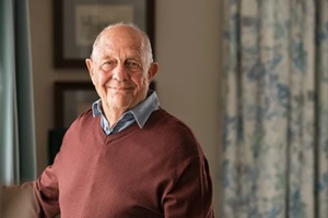happy aging parent looking at camera at home