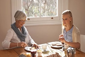 senior mother and eating breakfast