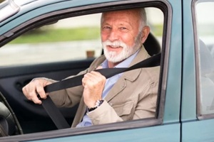 old man applying seat belt in the car