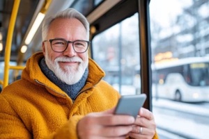 senior man smiling while travelling in a bus