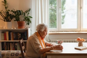 side view of elderly lady reading a book