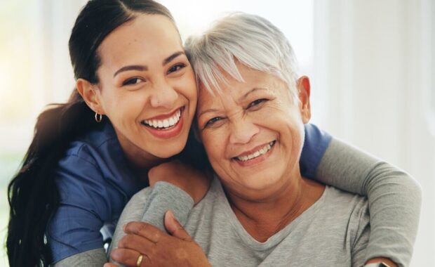 nurse and hug senior patient in elderly care, support or trust at old age home