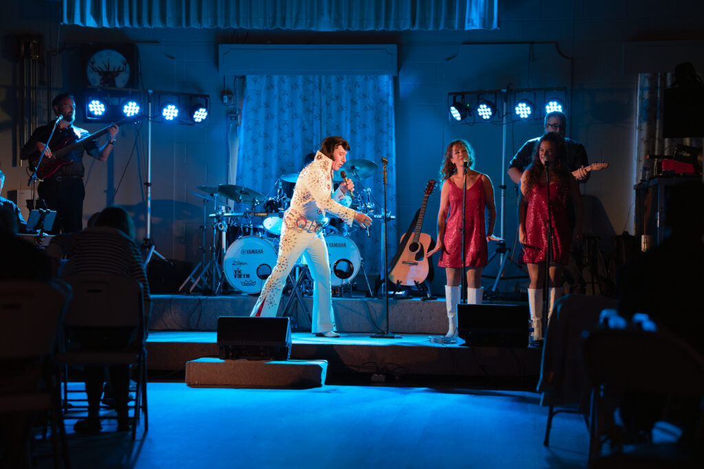elvis impersonator performs on stage at the scnova annual fundraiser