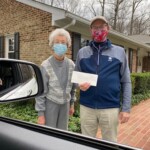 Senior couple holding check